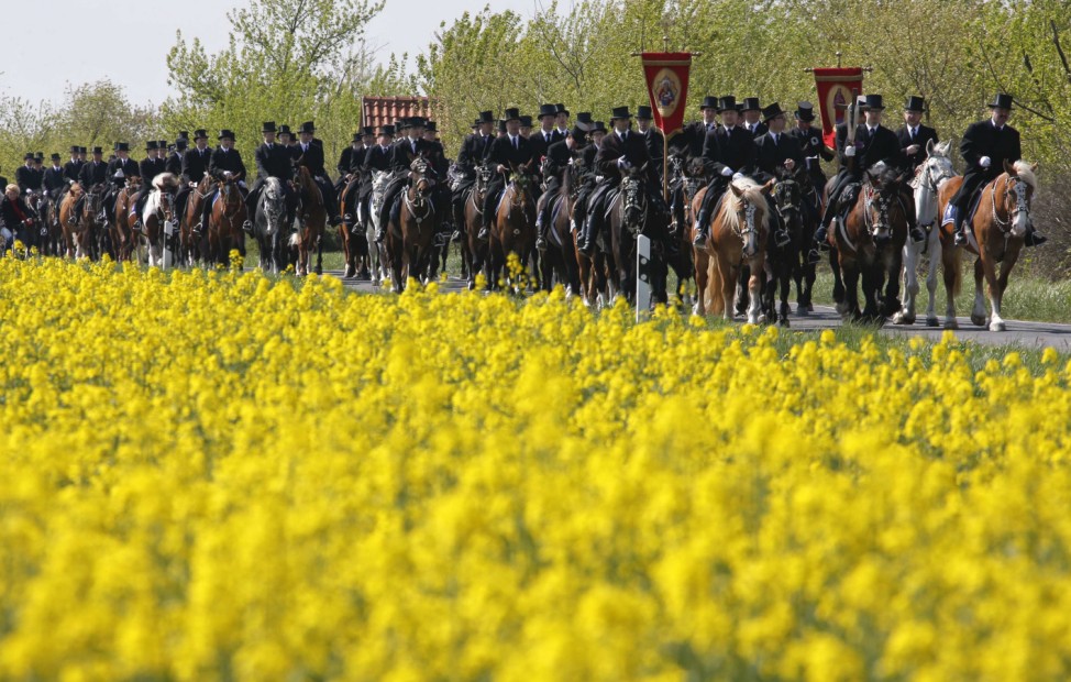 Men of the German Slavic minority Sorbs ride horses during a ceremonial Easter parade near the village of Ralbitz