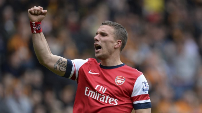 Arsenal's Podolski celebrates after scoring a second goal against Hull City during their English Premier League soccer match at the KC Stadium in Hull