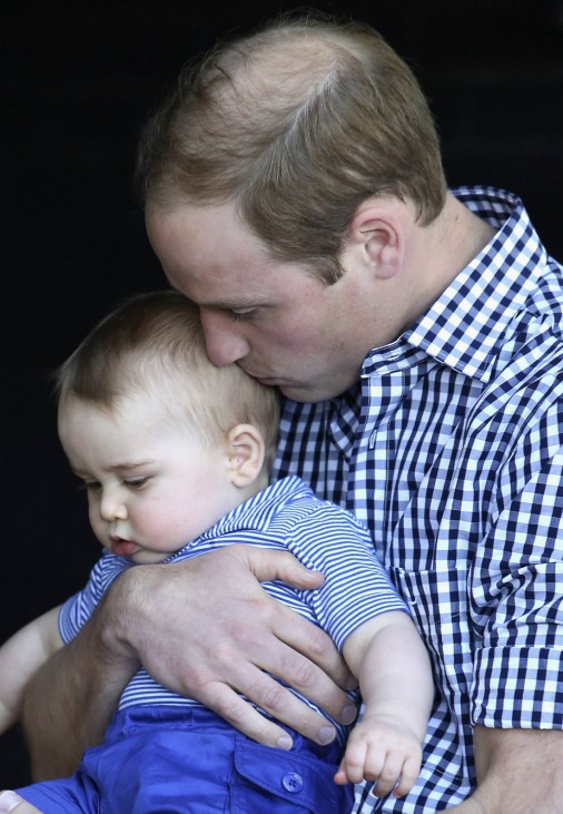 Britain's Prince William kisses his son Prince George as they meet a Bilby which has been named after the young prince at Taronga Zoo in Sydney