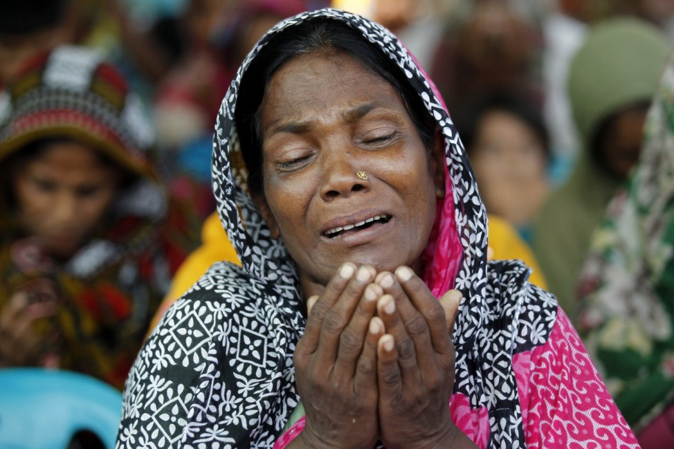 A relative of a garment worker, who went missing in the Rana Plaza collapse, takes part in a mass prayer on the first year anniversary of the accident, at a school in Savar