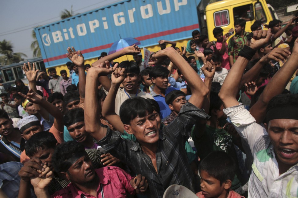 People shout slogans on the first year anniversary of the Rana Plaza collapse, as they gather in Savar