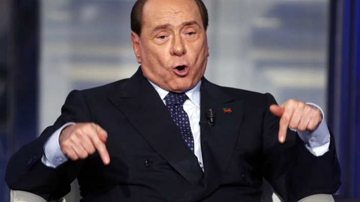 Italy's former Prime Minister Berlusconi gestures as he appears as a guest on the RAI television show Porta a Porta (Door to Door) in Rome