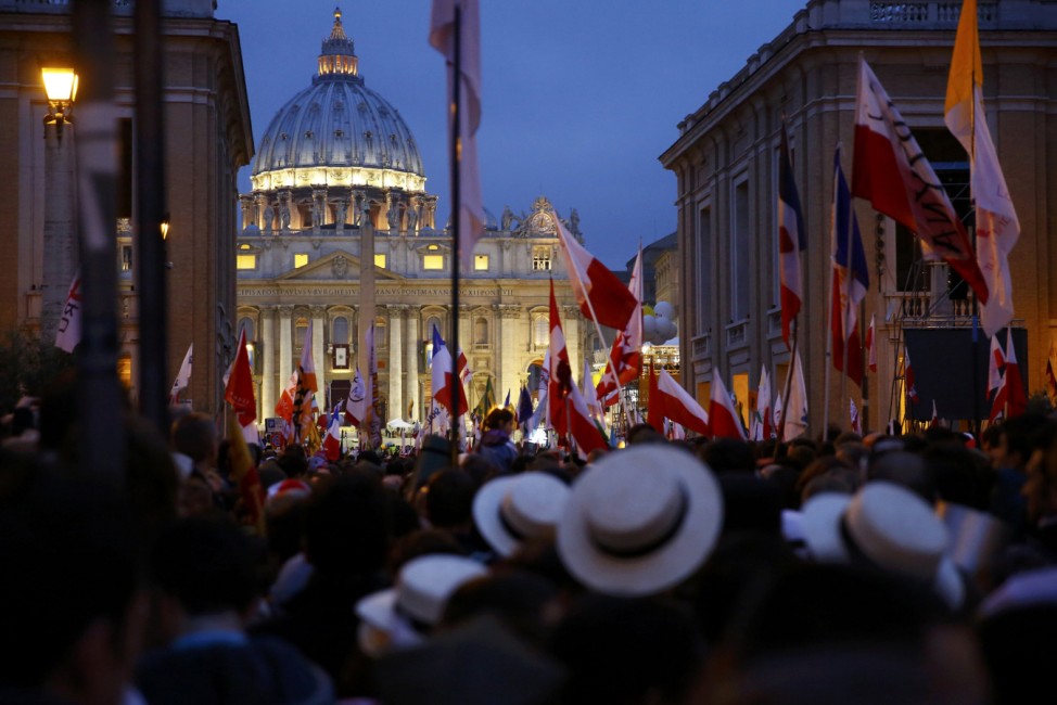 Polish pilgrims wait for mass before the canonisation ceremony in St Peter's Square at the Vatican
