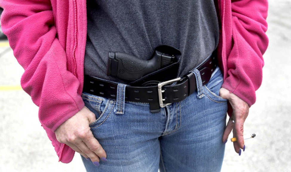 Gloria Lincoln-Thompson carries her 9mm Smith & Wesson pistol in her waist band during a rally in support of the Michigan Open Carry gun law in Romulus, Michigan