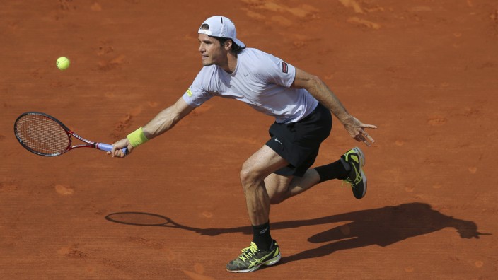 Haas of Germany hits a return to Djokovic of Serbia during their men's singles quarter-final match at the French Open tennis tournament in Paris