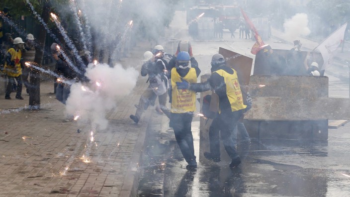 Fireworks explode near protesters during a May Day demonstration in Istanbul