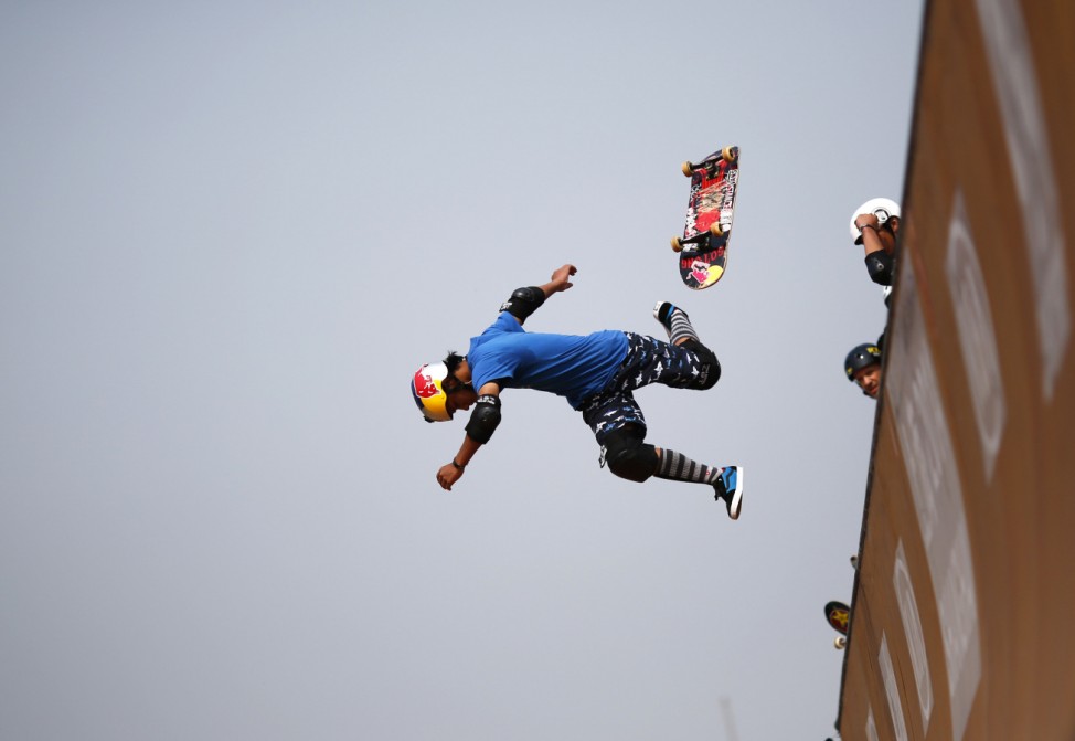A skateboarder falls as he competes at the vert ramp during the World Extreme Games in Shanghai