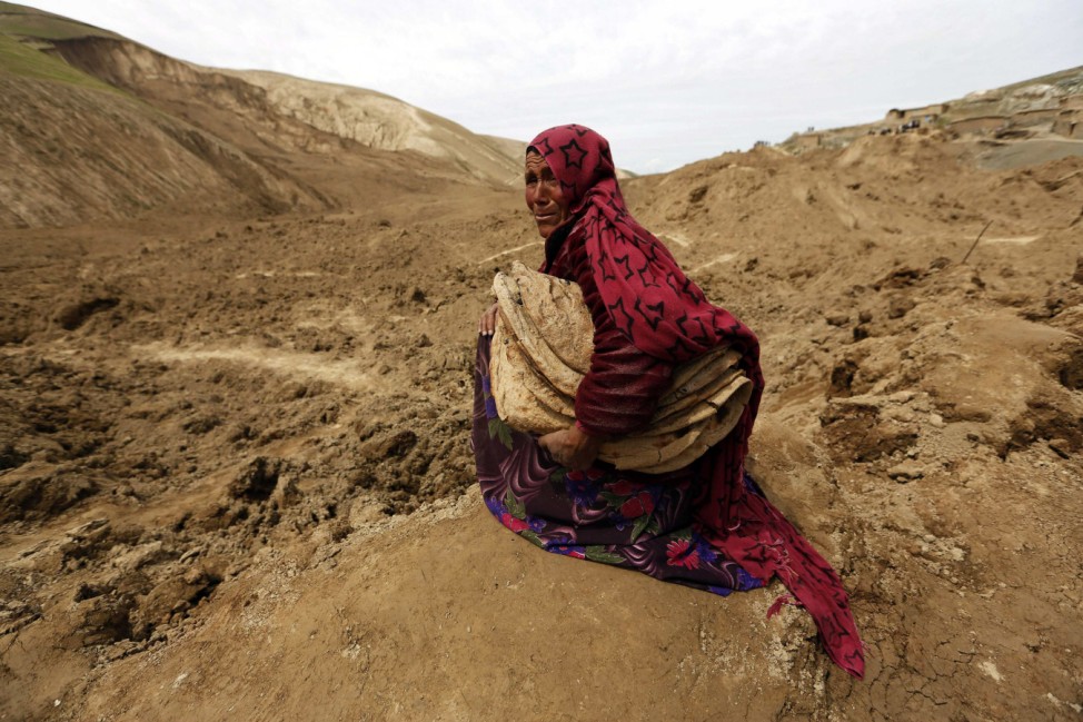 An Afghan woman cries after she lost her family in a landslide at the Argo district in Badakhshan province