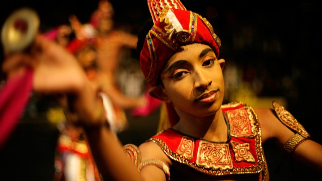 Kandyan dancer performs in front of Sri Dalada Maligawa during Esala Perahera festival in ancient hill capital of Kandy
