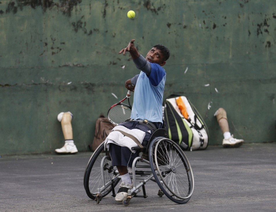 Gamini Dissanayake, 36, an army soldier and member of Sri Lanka's wheelchair tennis national team serves during a practice session in Colombo