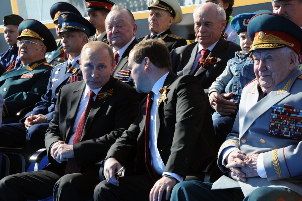Vladimir Putin and Dmitry Medvedev attend a military parade in Mo