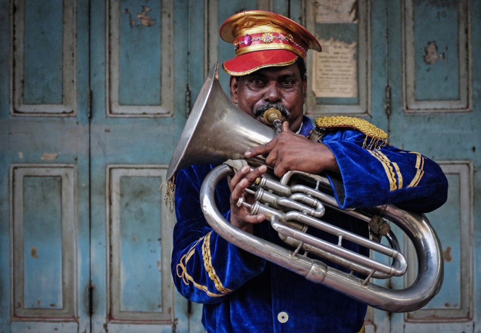 A member of local band plays instrument during marriage ceremony in Mumbai