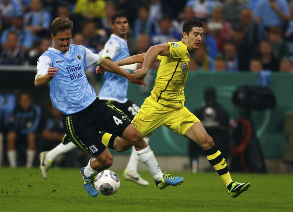 Borussia Dortmund's Lewandowski fights for the ball with Buelow of TSV 1860 Munich during their DFB-Pokal match in Munich