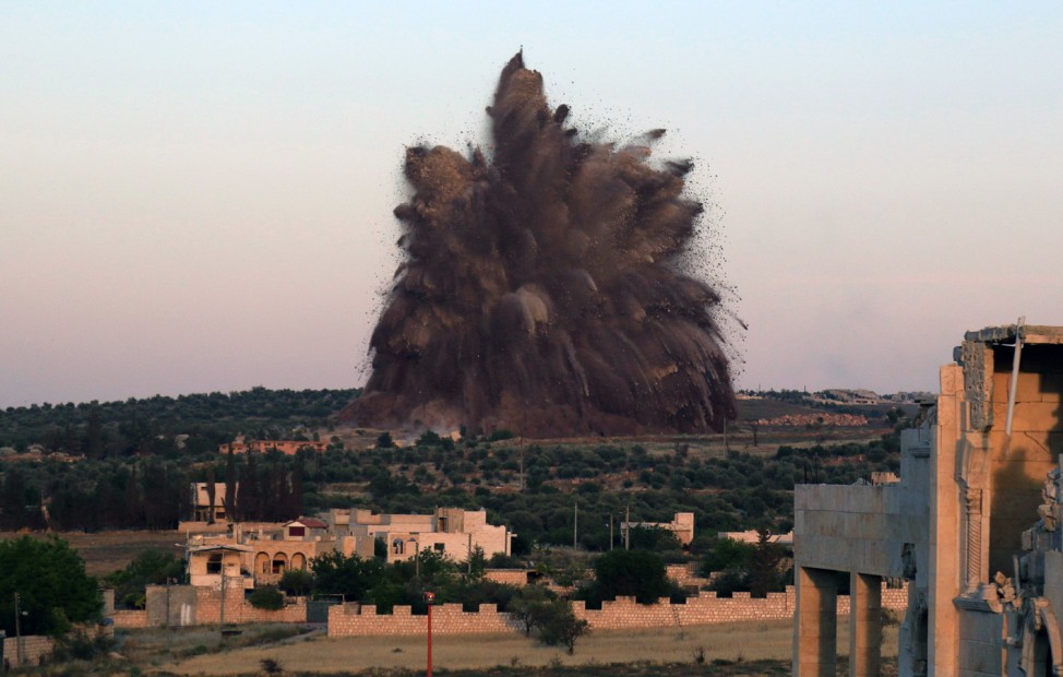 Debris rises during what rebel fighters said was an operation in which they blew up a tunnel targeting the regime's al-Sawadi checkpoint, in Idlib province