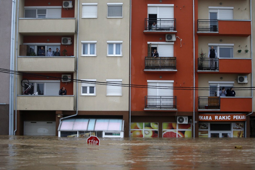 People look out from their apartments as they wait to be evacuated in the town of Obrenovac, east from Belgrade