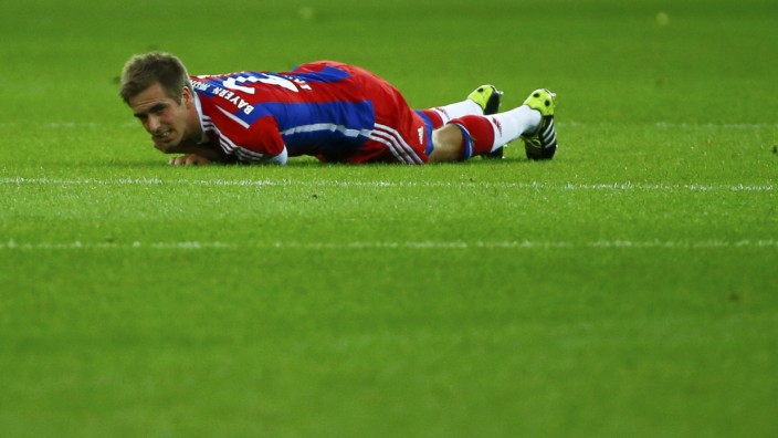 Bayern Munich's Lahm lies injured on the pitch during their German Cup (DFB Pokal) final soccer match against Borussia Dortmund in Berlin