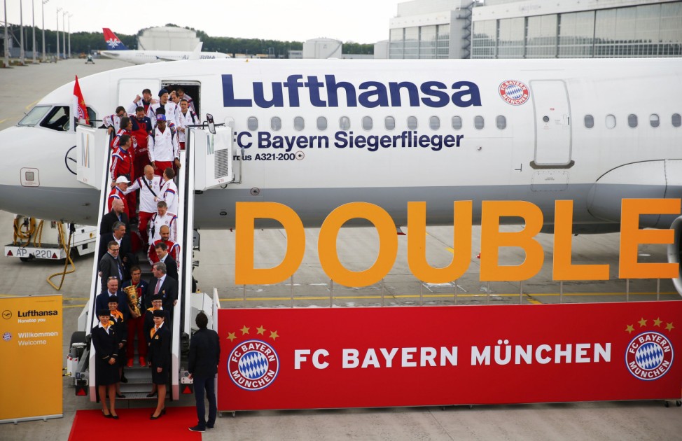 Bayern Munich's players and officials leave the plane after landing in Munich's airport