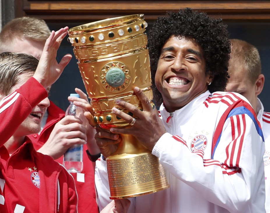 Bayern Munich's Dante holds the German Cup trophy at the balcony of the town hall during celebrations after their German Cup final against Borussia Dortmund, in central Munich