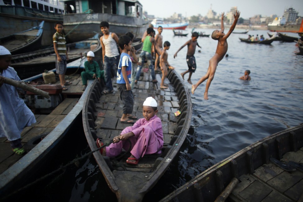 Children play at a shipyard by the river Buriganga, on the outskirts of Dhaka
