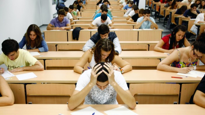 Students take a university entrance examination at a lecture hall in the Andalusian capital of Seville