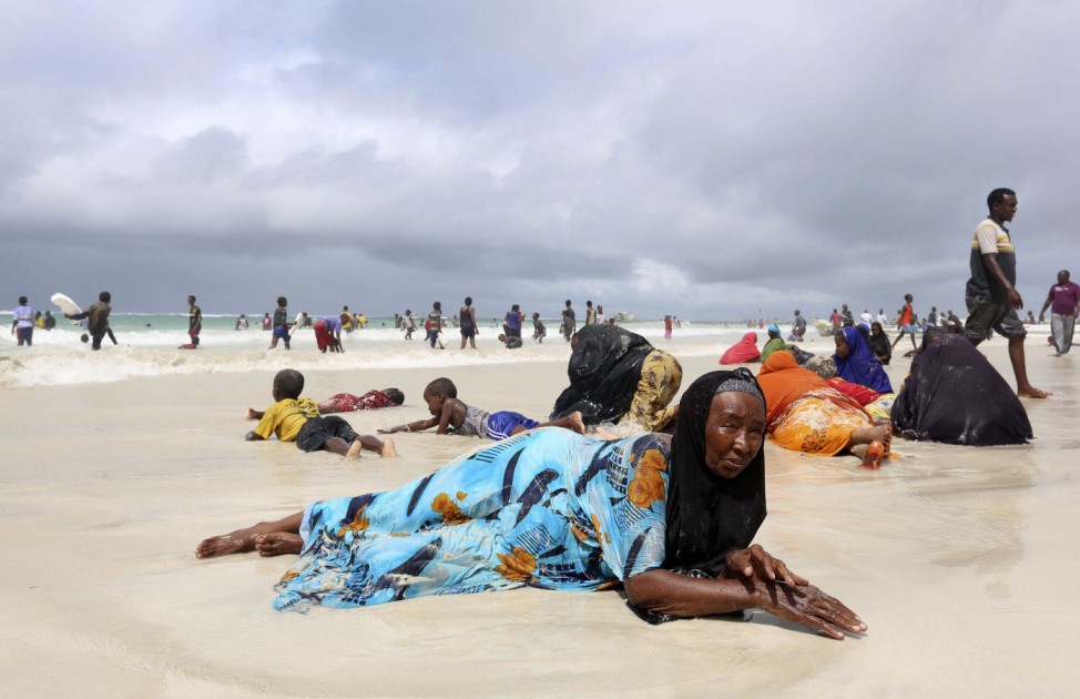 Women and children lie on the sand at Lido beach, north of Somalia's capital Mogadishu