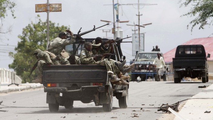 Somali government soldiers ride in their truck as they take up positions outside the Parliament building during a clash with Al Shabaab militants in the capital Mogadishu
