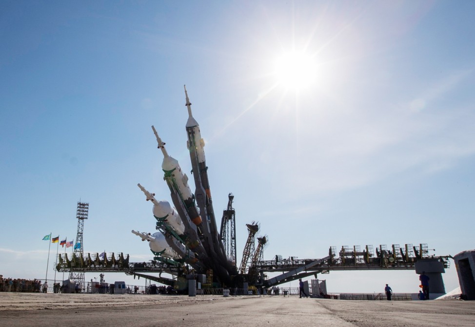 A picture taken using in-camera multi-exposure function shows the Soyuz TMA-13M spacecraft being lifted on its launch pad at Baikonur cosmodrome