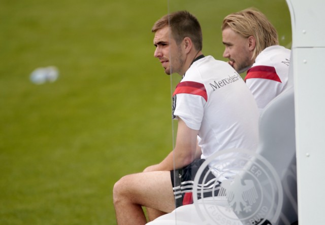 German national soccer player Lahm and Schmelzer watch a test match against the German U20 soccer team in St. Martin