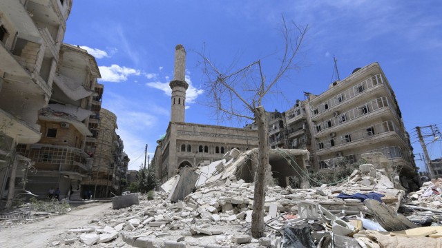 Debris and damage are pictured at a site hit by what activists said was an air strike by forces loyal to Syria's President Assad in al-Shaar neighbourhood of Aleppo