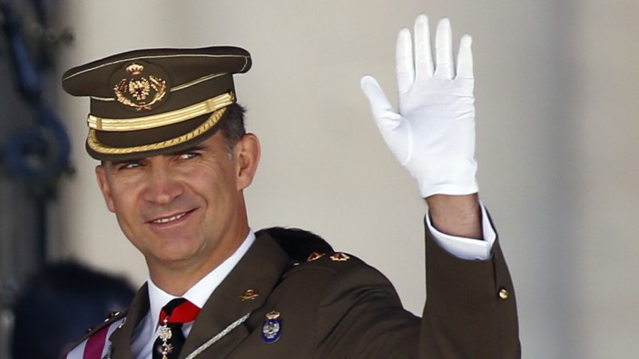 Spain's Crown Prince Felipe waves during a ceremony at the Monastery of San Lorenzo de El Escorial outside Madrid