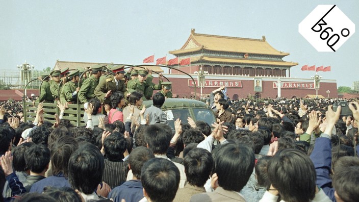 Chinese marchers are jubilant as they surround and stop an army truck at...
