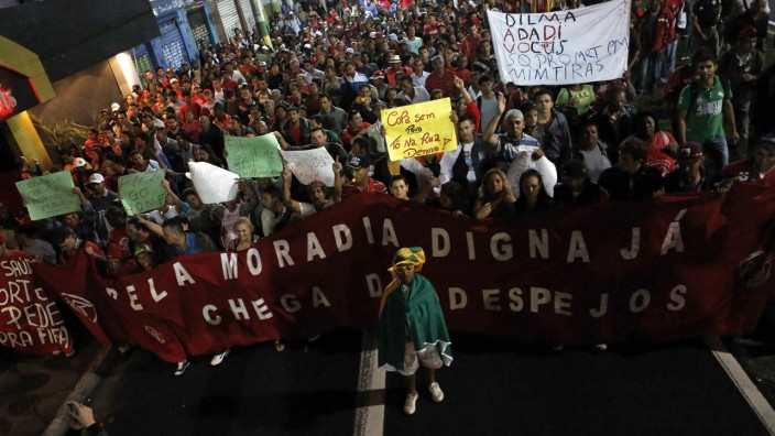 Members of Brazil's Homeless Workers' Movement block a road during a protest near Sao Paulo's World Cup stadium