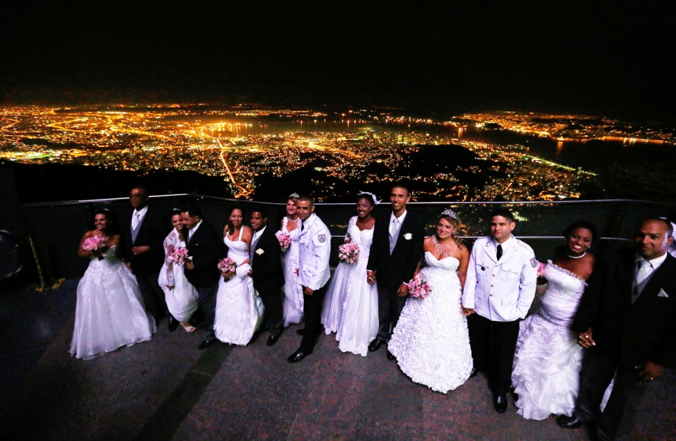 Couples wait to leave the Corcovado mountain after being wed during a group marriage in Rio de Janeiro