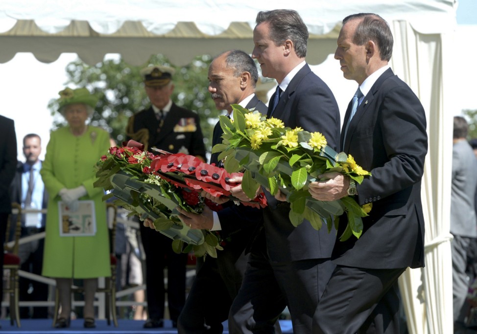 Governor-General of New Zealand Mateparae, British Prime Minister Cameron and Australia's Prime Minister Abbott lay wreaths during the French-British ceremony at the British War cemetery in Bayeux