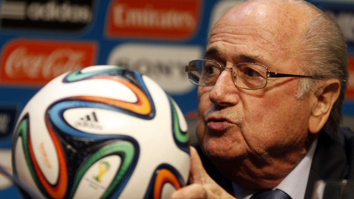 FIFA President Blatter holds an official 2014 FIFA World Cup soccer ball during a media conference in Sao Paulo
