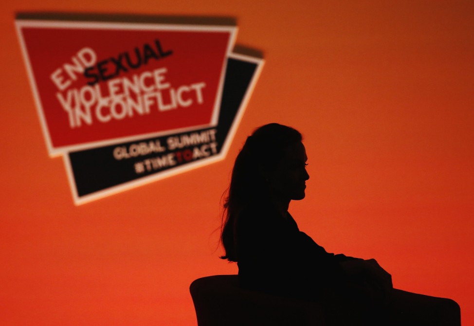 Actress and campaigner Angelina Jolie is silhouetted as she attends a summit to end sexual violence in conflict, at the Excel centre in London