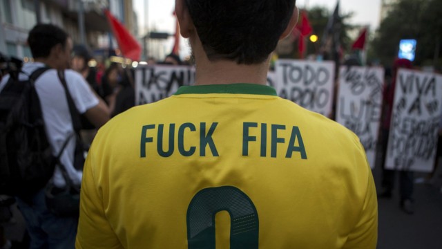 A protester wears a Brazilian national soccer jersey modified for a demonstration  in Rio de Janeiro