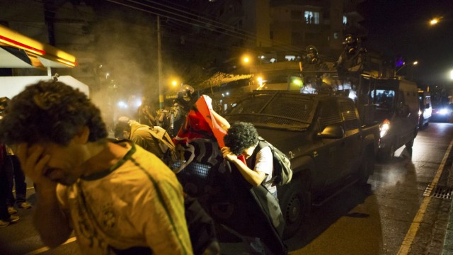 Riot police spray tear gas at protesters in Rio de Janeiro