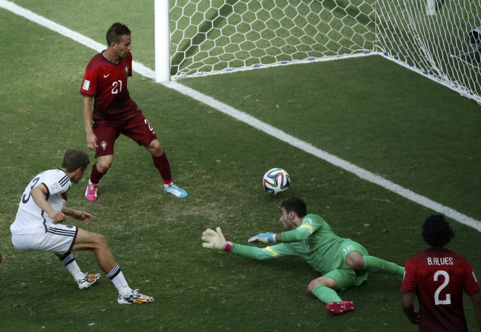 Germany's Mueller shoots to score against Portugal for his hat-trick during their 2014 World Cup Group G soccer match at the Fonte Nova arena in Salvador