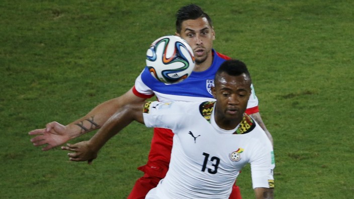 Cameron of the U.S. fights for the ball with Ghana's Ayew during their 2014 World Cup Group G soccer match at the Dunas arena in Natal