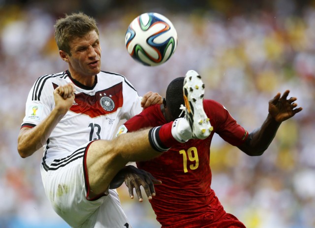 Germany's Mueller fights for the ball with Ghana's Mensah during their 2014 World Cup Group G soccer match at the Castelao arena in Fortaleza