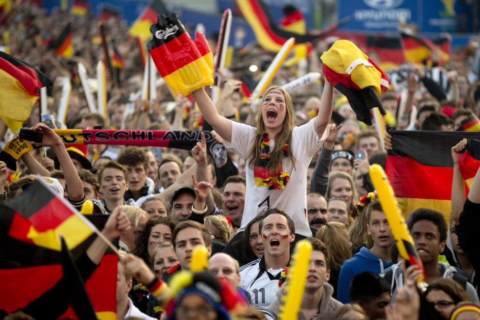 German soccer fans cheer during 2014 World Cup Group G soccer match between Germany and Ghana at a public viewing zone called 'fan mile' in Berlin