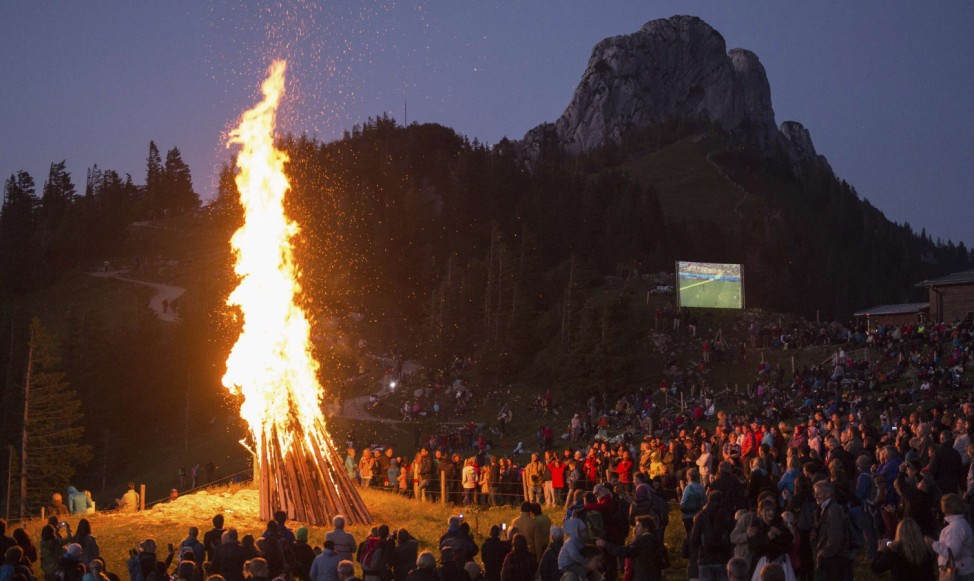 People watch World Cup match between Germany and Ghana during the Sonnwendfeuer Festival at Mt. Kampenwand