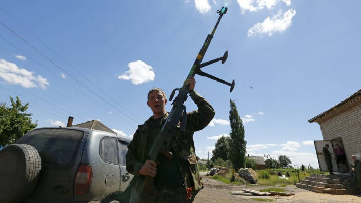 A pro-Russian separatist shows an anti-tank rifle in Seversk, Donetsk region