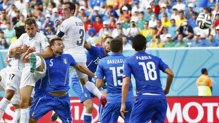 Uruguay's Diego Godin heads the ball to score a goal against Italy during their 2014 World Cup Group D soccer match at the Dunas arena in Natal