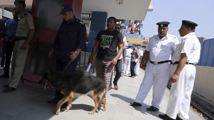 A canine unit inspects the area of a blast in Shubra El-Kheyma metro station in Greater Cairo