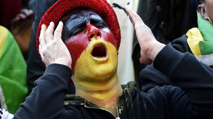 A fan of Germany reacts during a public viewing event of their 2014 World Cup soccer match against Ghana in Hamburg