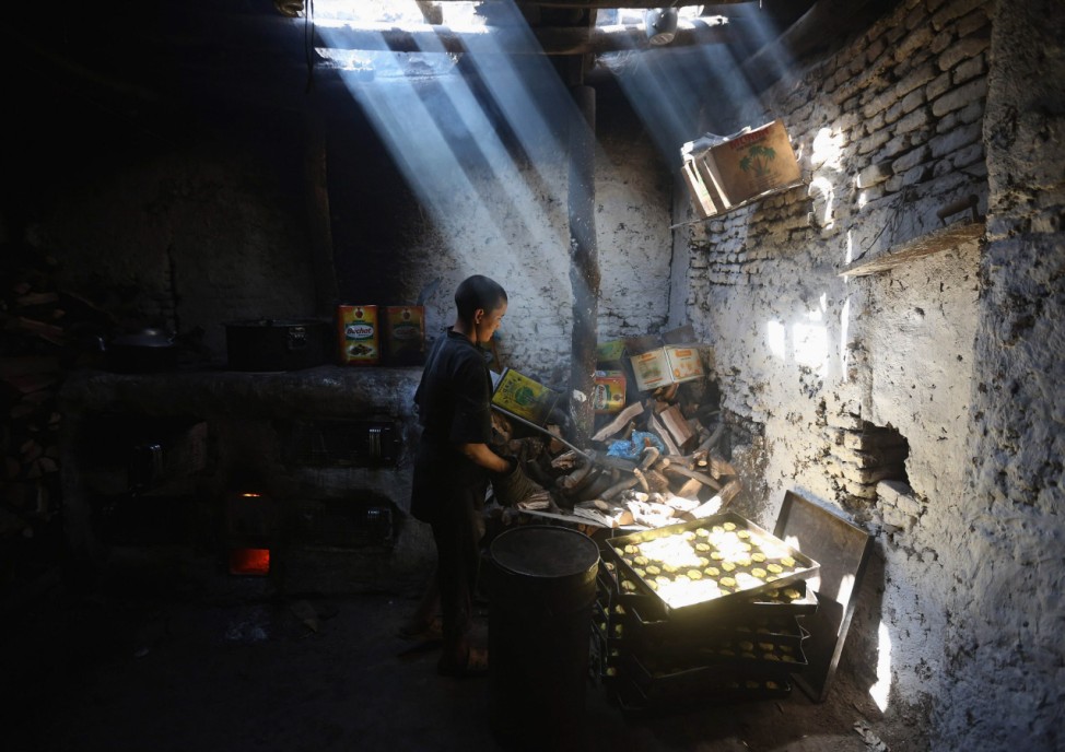 Young man prepares special sweets at small traditional factory first day of the holy month of Ramadan in Kabul