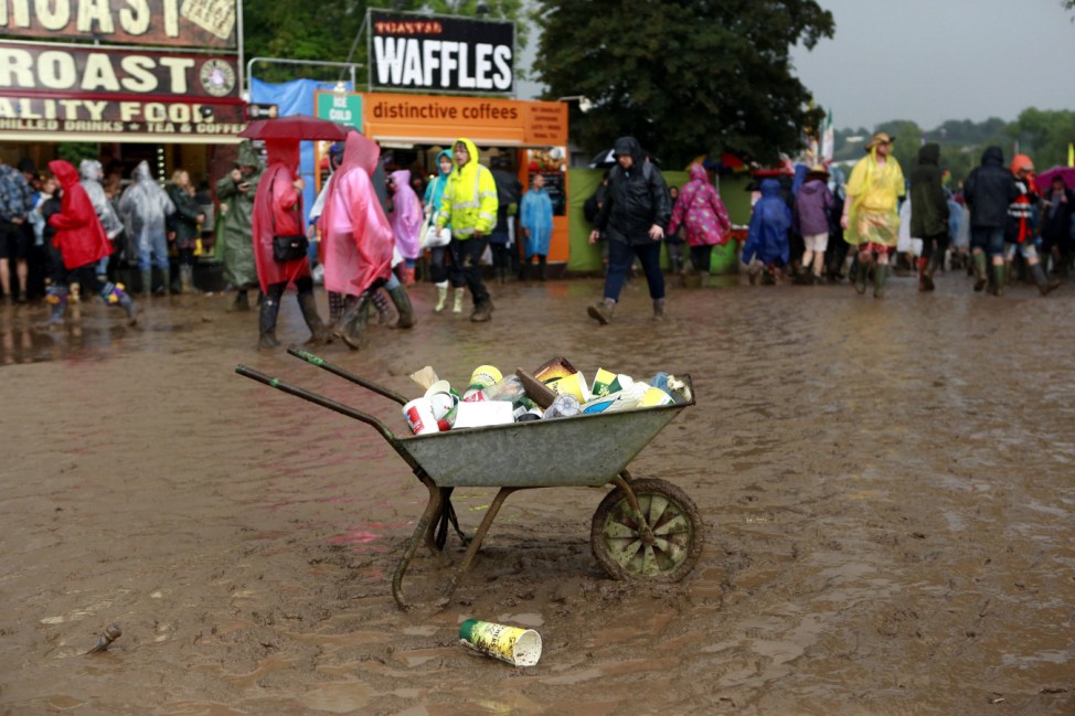 A wheelbarrow filled with rubbish sits near the Pyramid stage at Worthy Farm in Somerset, during the Glastonbury Festival