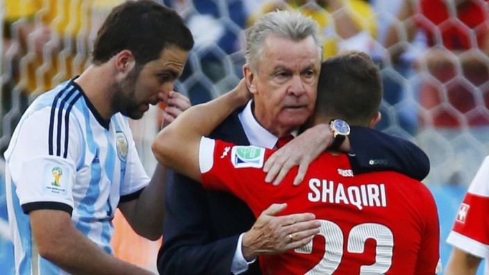 Switzerland's coach Hitzfeld embraces player Shaqiri after they were defeated in extra time in their 2014 World Cup round of 16 game against Argentina at the Corinthians arena in Sao Paulo